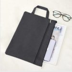 black document bag with black sunglasses and iphone