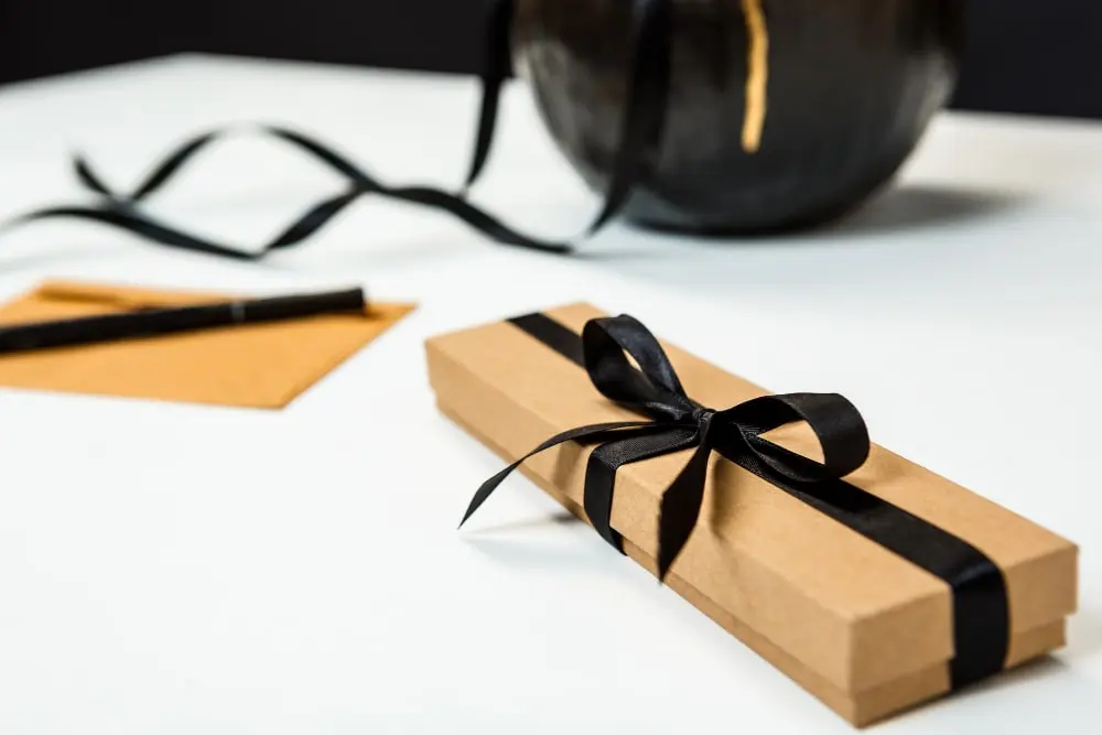 a single corporate gifts covered brown cardboard and black ribbon for what is corporate gifts