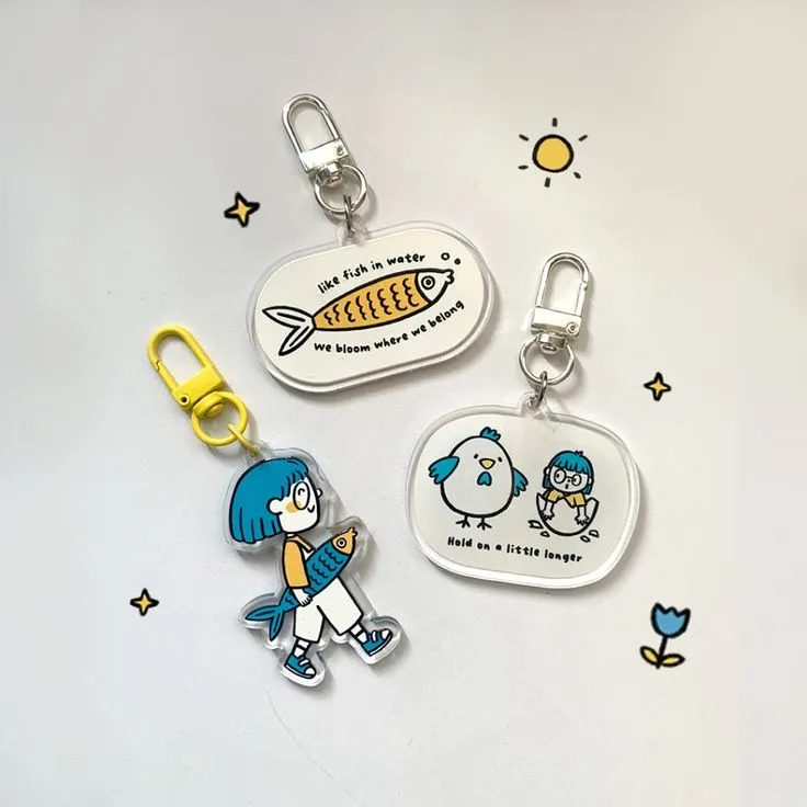 three acrylic keychains with blue and white color