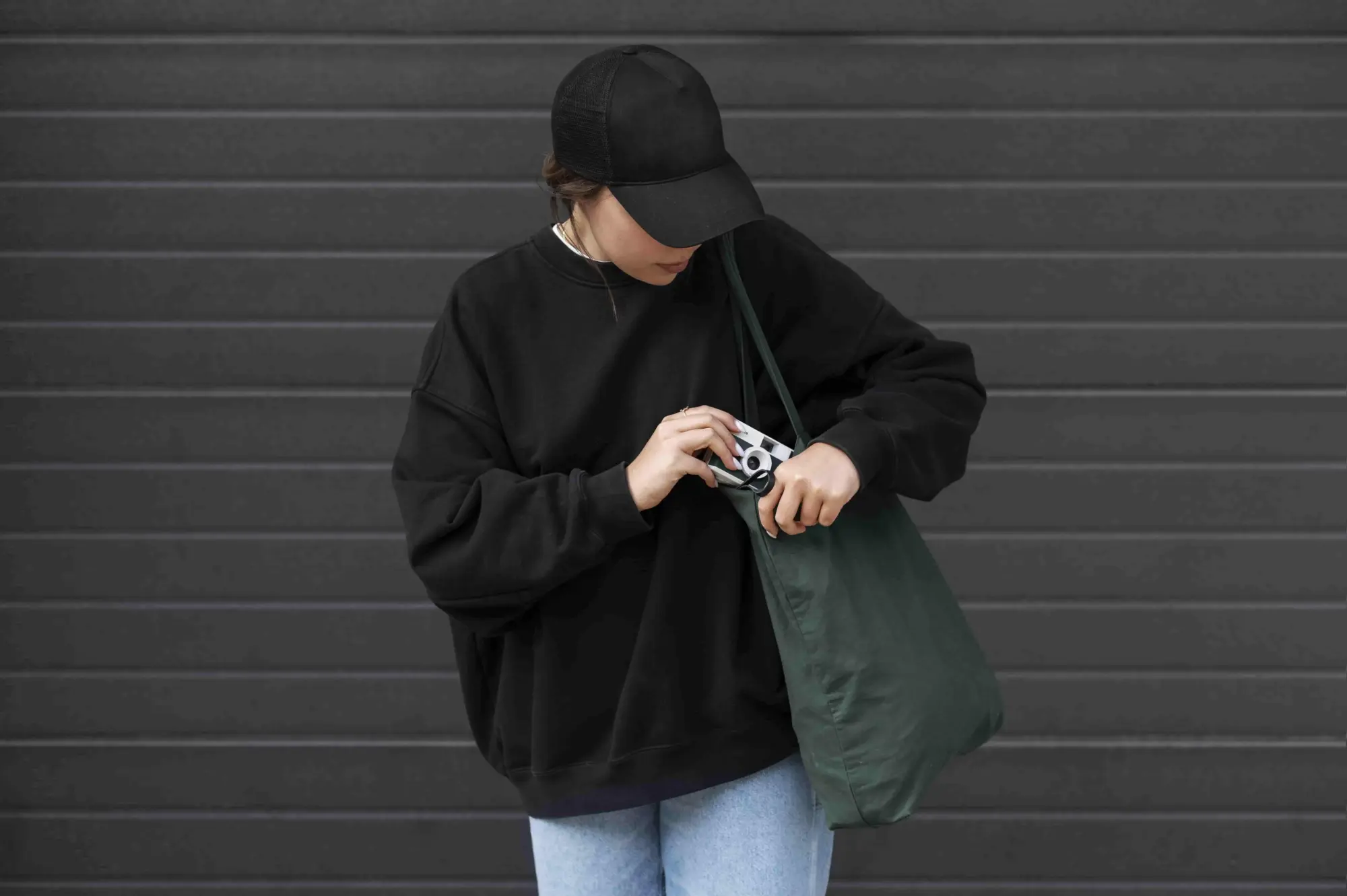 young woman wearing trucker hat and green consumer bags