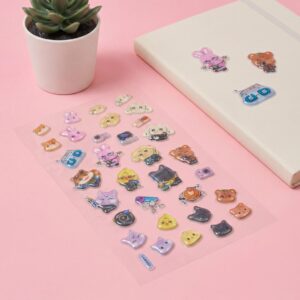 Cute animal-themed 3D crystal bubble stickers sheet displayed on a pastel pink surface with a journal.